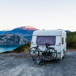 camper on edge of cliff with bike