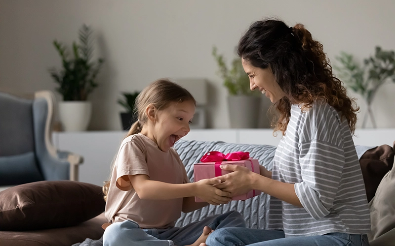 mom giving daughter a gift