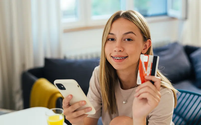 teen holding credit card