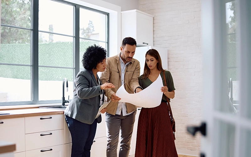 couple looking at plans in kitchen