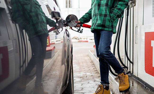 person putting gas in their car