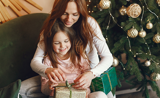 mom and daughter opening gift