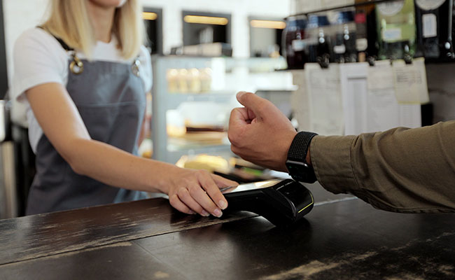 person using wearable to pay for goods