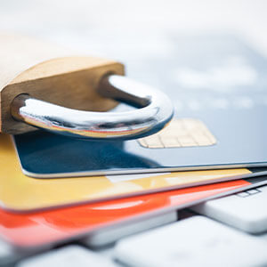 lock sitting on top of three credit cards