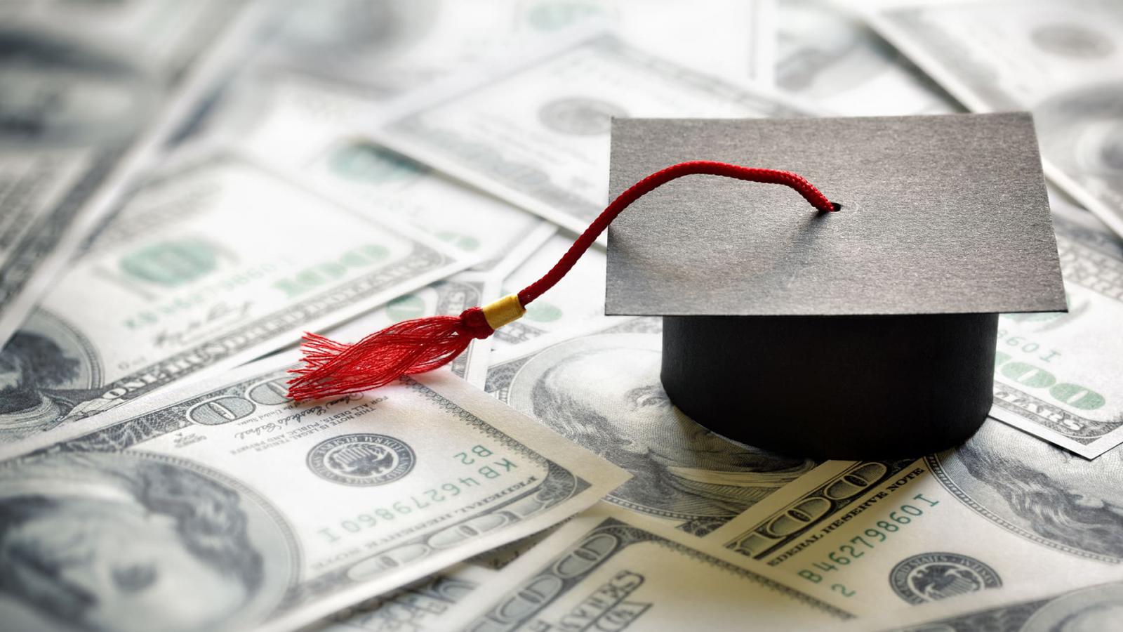 small graduation cap on cash money