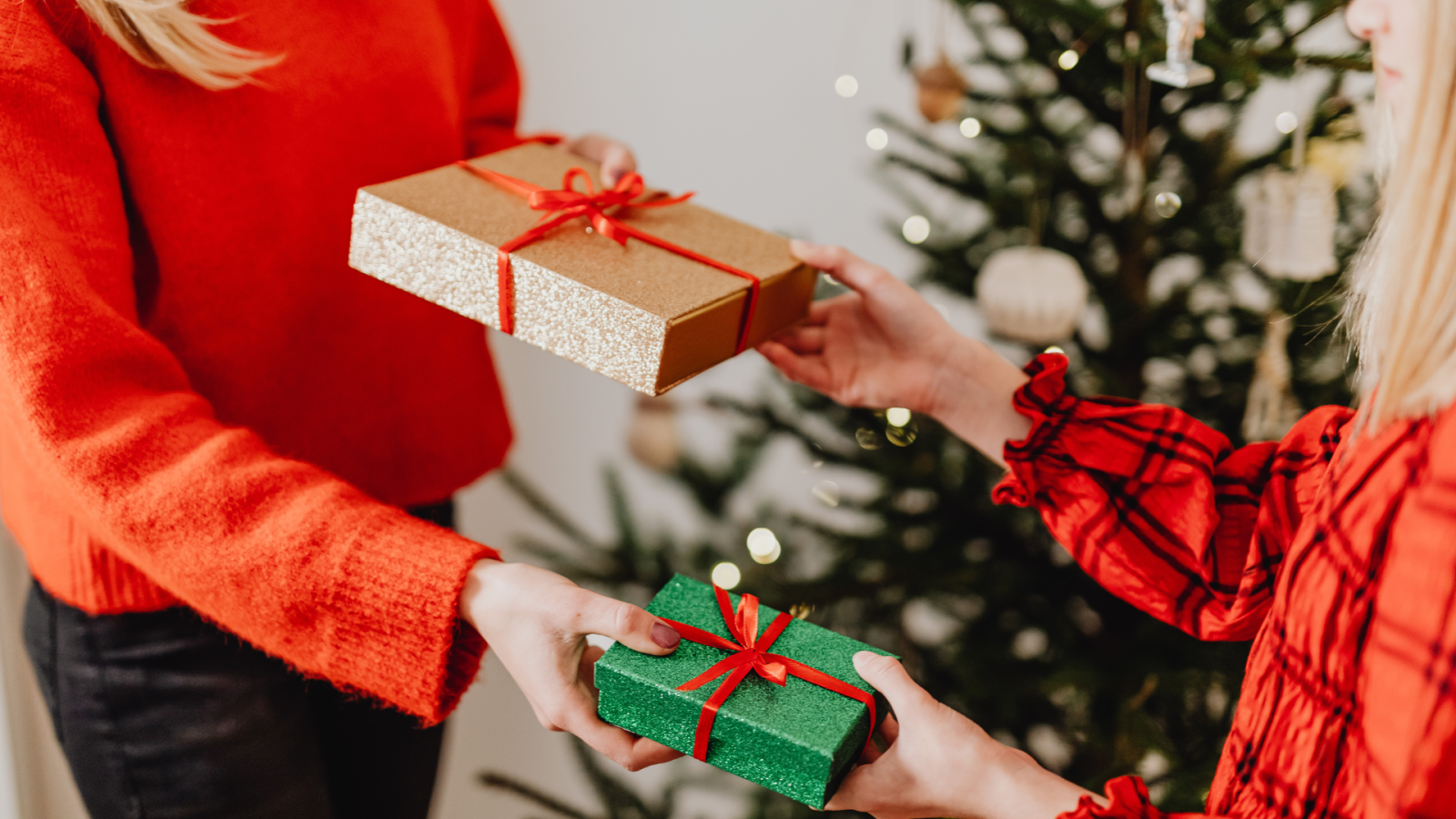 two ladies giving each other gifts