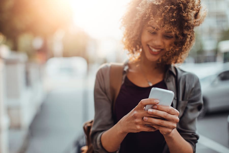 young woman outdoors on her phone